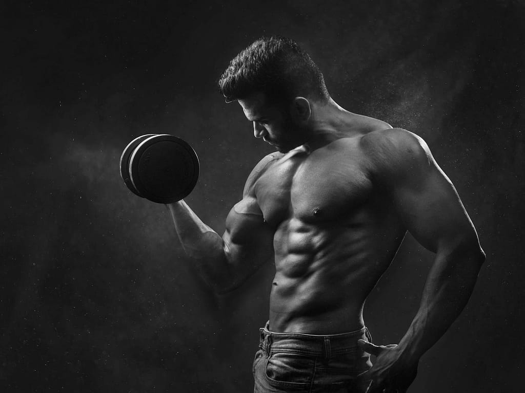 man holding black dumbbell