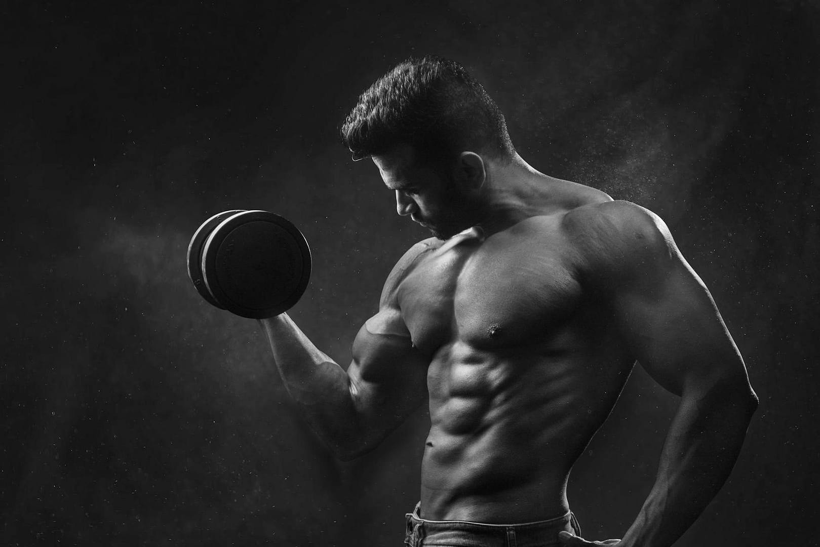 man holding black dumbbell